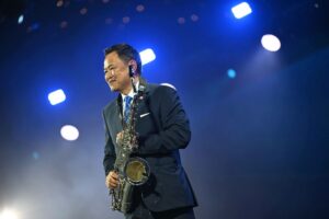 Anutin Plays Saxophone at IMF-World Bank Reception While Hundreds Protest in Bangkok